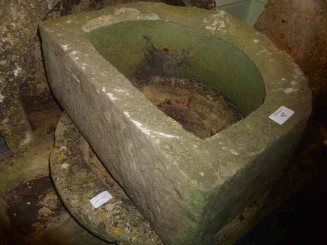 Appraisal: A ROUGH HEWN STONE SINK of circular form diameter together