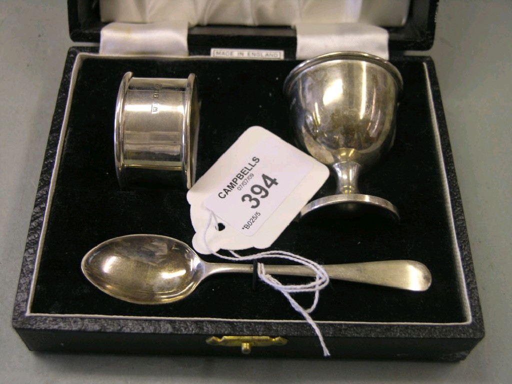 Appraisal: A silver christening trio consisting of eggcup napkin ring and