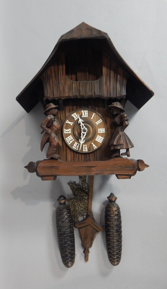 Appraisal: A Black Forest carved pine cuckoo clock the front cast