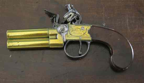 Appraisal: A brass framed brass barrelled O U tap action flintlock