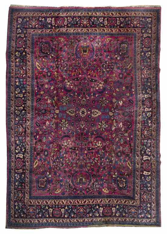 Appraisal: A Sarouk Wool Rug having a stylized foliate center medallion