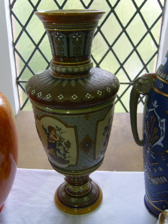 Appraisal: A th century Mettlach vase with reserve panels of cherubs