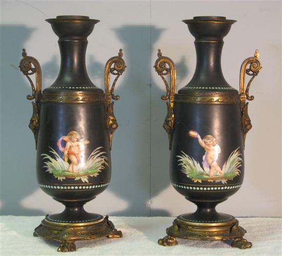 Appraisal: Pair of th century porcelain vases decorated with cherubs with