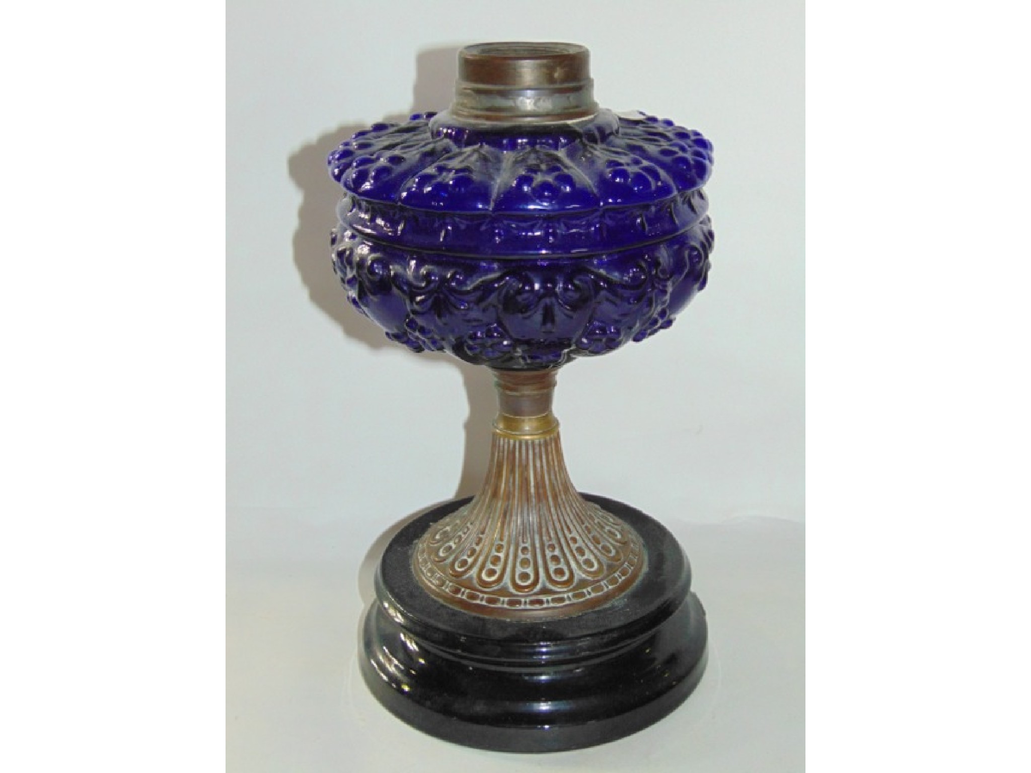 Appraisal: A late th century oil lamp with transparent blue moulded