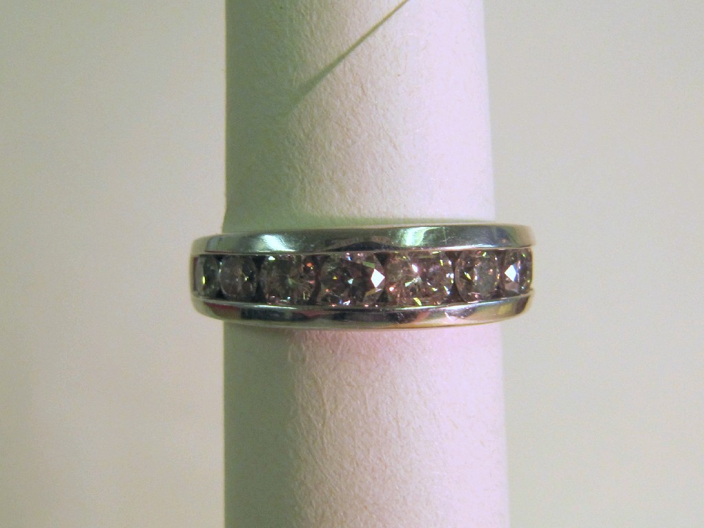 Appraisal: Platinum graduated channel set diamond half hoop ring with nine