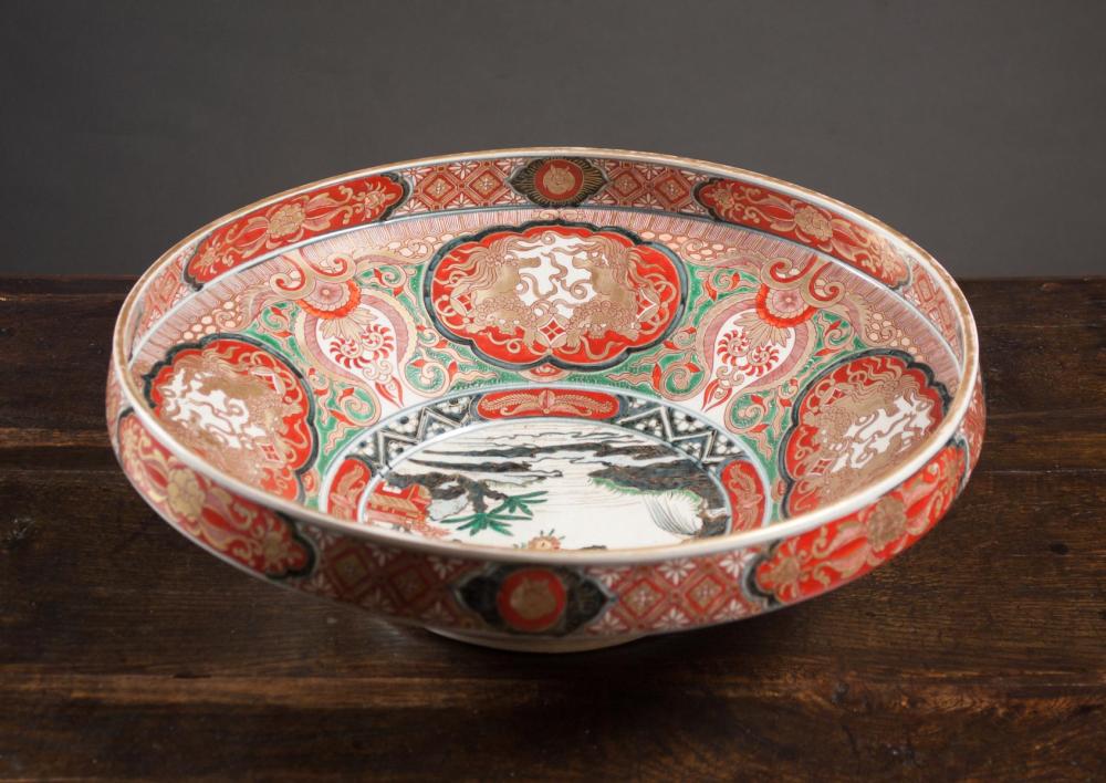 Appraisal: JAPANESE IMARI PORCELAIN CENTERPIECE BOWL featuring a landscape reserve at