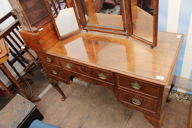 Appraisal: A GEORGIAN STYLE WALNUT LOWBOY with cross banded top and