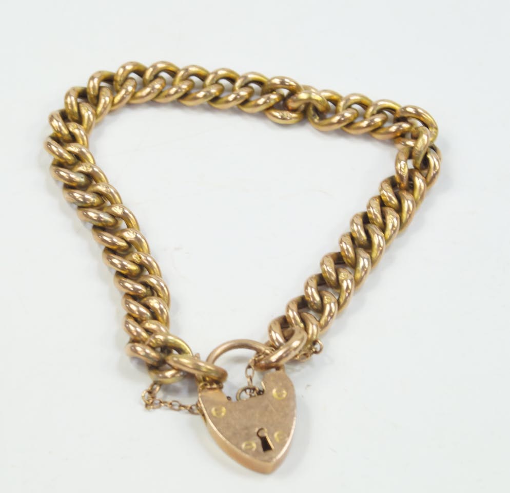 Appraisal: A hollow curb link bracelet with padlock clasp stamped C