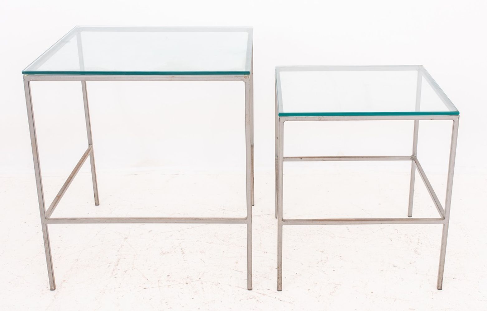 Appraisal: POST MODERN METAL AND GLASS NESTING TABLES Two Post Modern