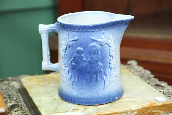 Appraisal: KITCHEN STONEWARE PITCHER Blue and white with a boy and