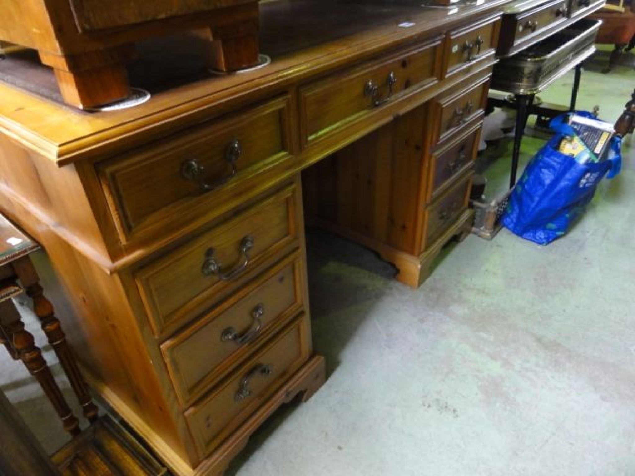 Appraisal: A reproduction stripped pine kneehole twin pedestal writing desk of