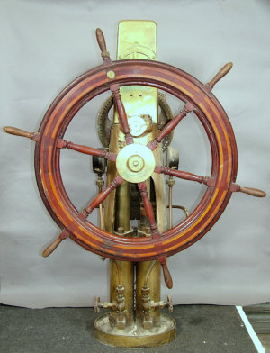 Appraisal: A teak mahogany ship's wheel fitted to brass steerage station