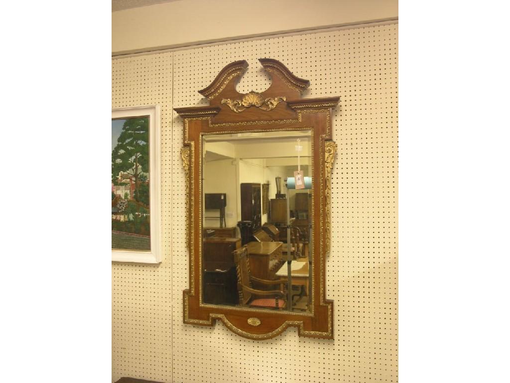 Appraisal: A George II-style walnut and parcel-gilt mirror architectural-shape with break-arch