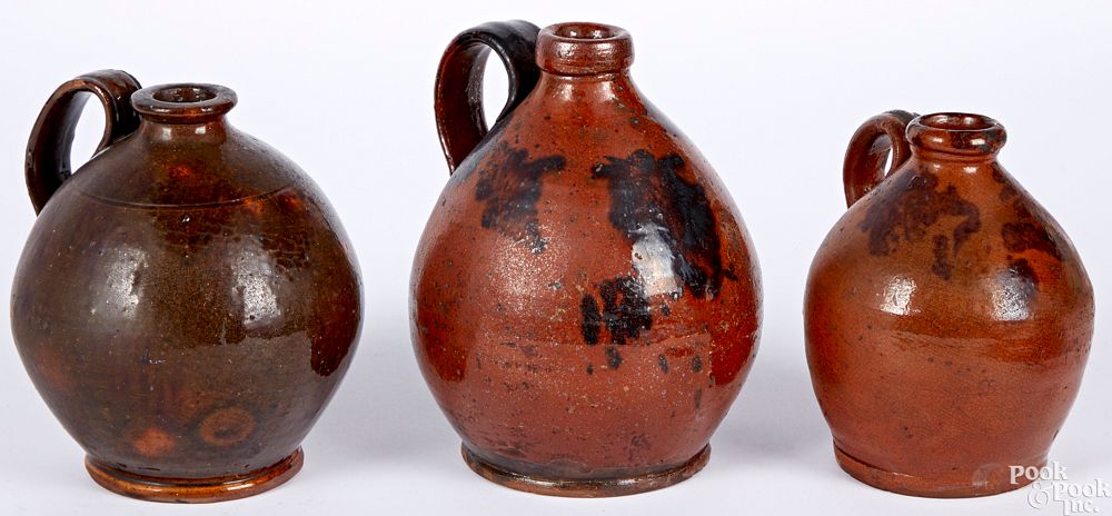 Appraisal: Three redware ovoid jugs Three redware ovoid jugs th c