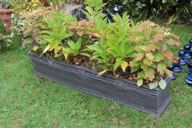 Appraisal: A SET OF THREE FAUX LEAD COMPOSITE TROUGHS wide x