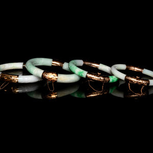 Appraisal: Four Chinese Metal Mounted Jadeite Bangles each of cylindrical form