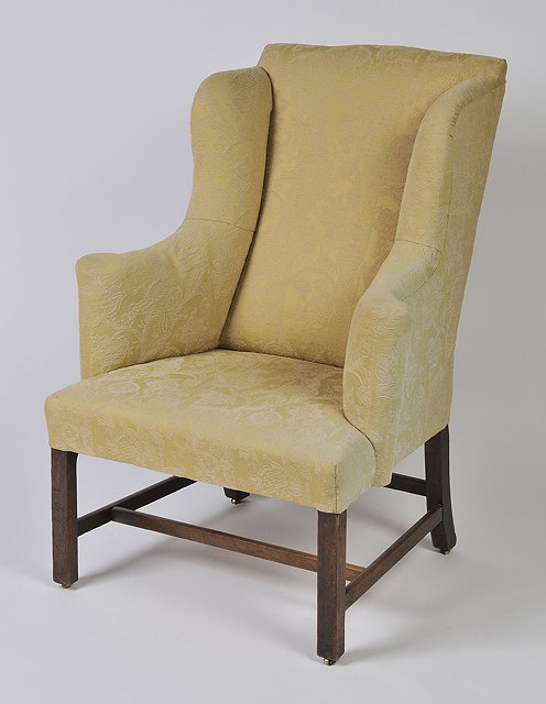 Appraisal: A GEORGE III OAK WINGBACK ARMCHAIR with later upholstered cover