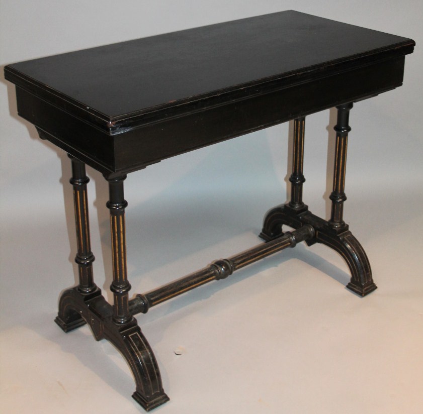 Appraisal: A thC Aesthetic style ebonised fold over games table the