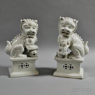 Appraisal: Pair of Blanc-de-chine Foo Lions one with his foot raised