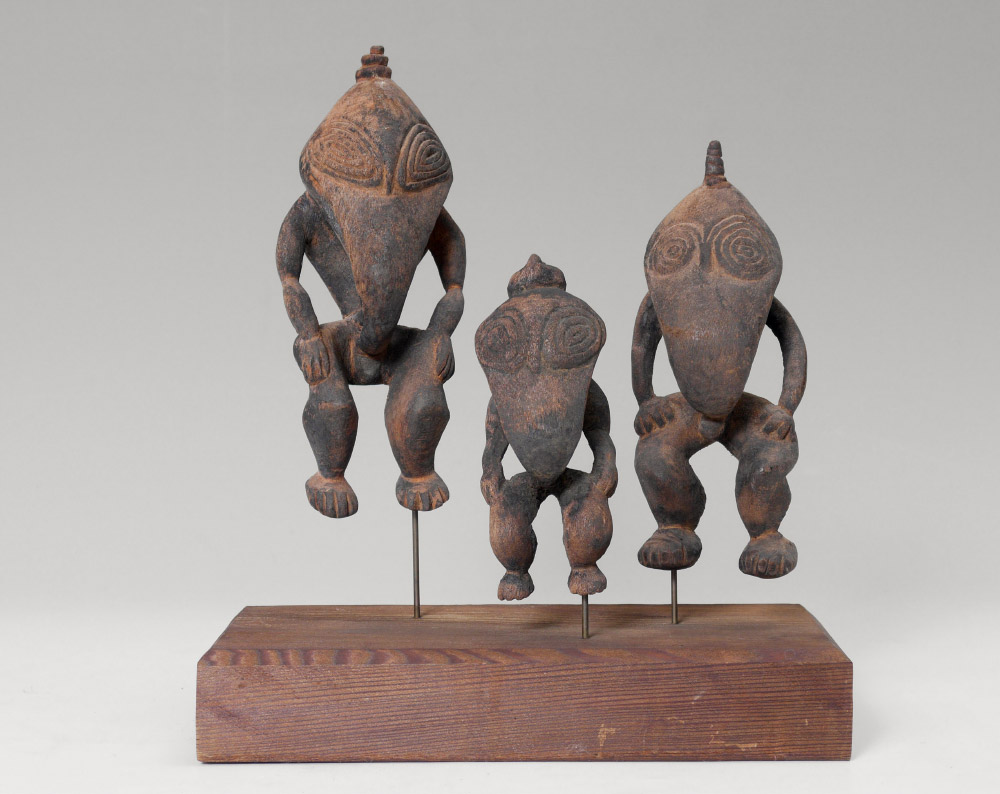 Appraisal: PIECE NEW GUINEA FIGURES ON STAND carved wood figures with