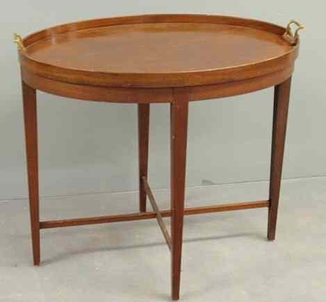 Appraisal: Regency style mahogany oval tray-on-stand with brass handles and cross