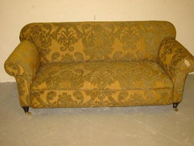 Appraisal: A VICTORIAN WALNUT FRAMED SOFA upholstered in old gold and