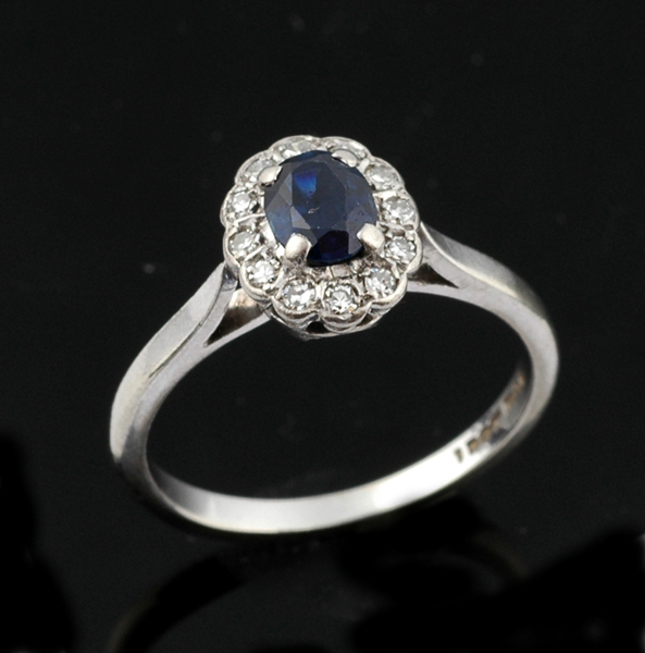 Appraisal: A sapphire and diamond ring The oval sapphire weighing cts