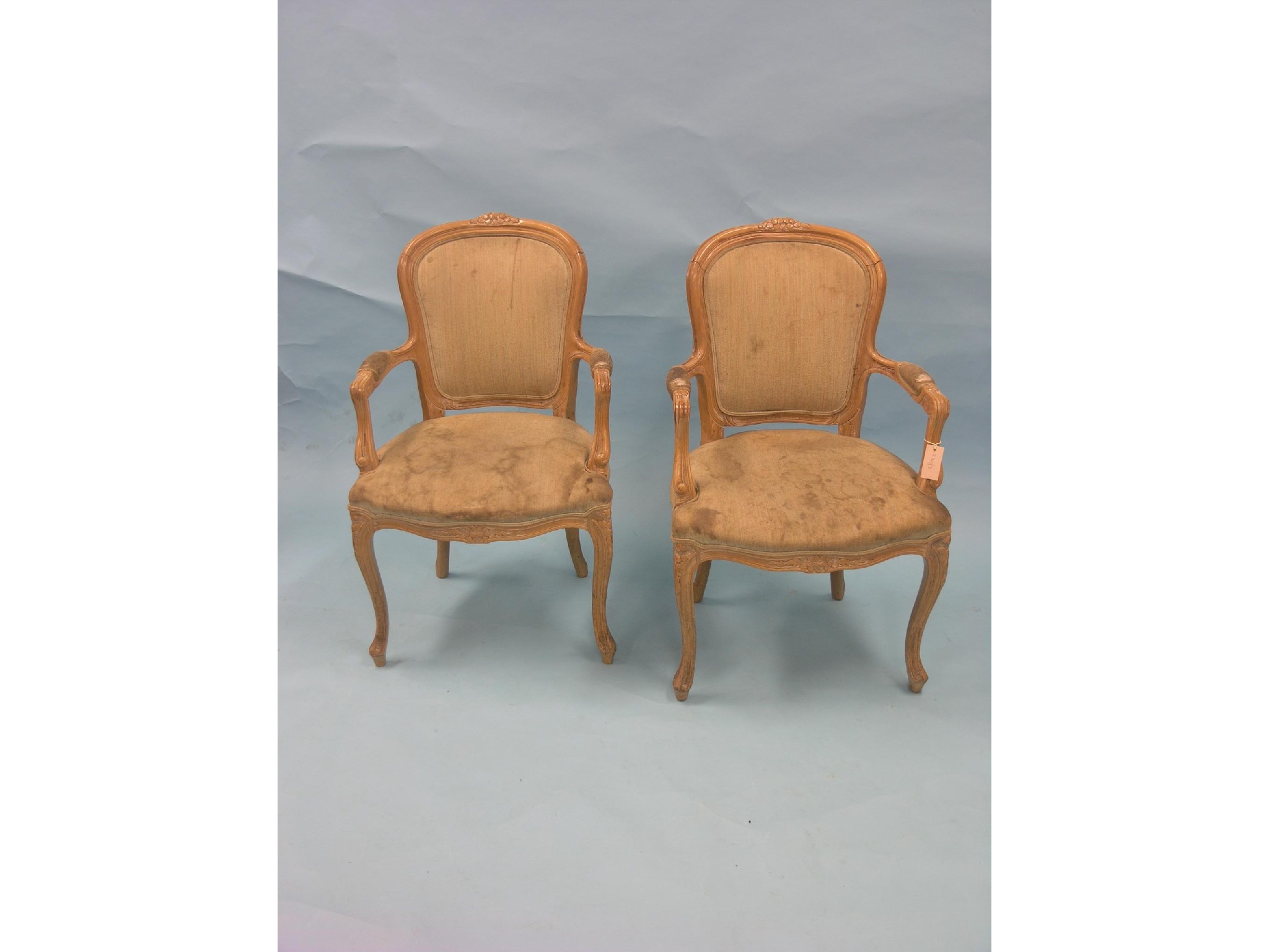 Appraisal: A pair of Louis XV-style light beech elbow chairs on