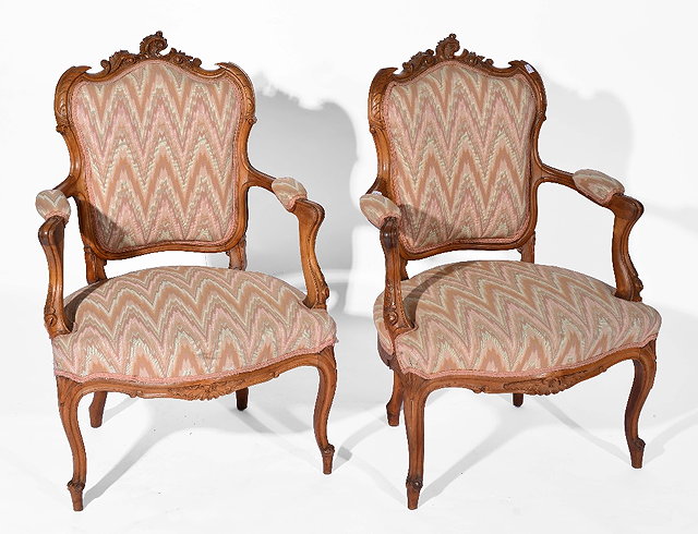 Appraisal: Pair of French walnut carved open armchairswith zigzag upholstery late