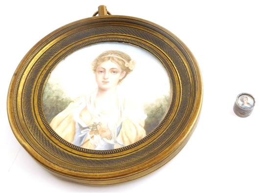 Appraisal: Two miniature portraits one watercolor on ivory round depicts young