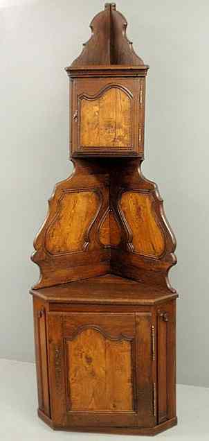 Appraisal: French Provincial oak and elm two-part corner cupboard th c