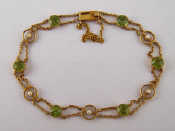 Appraisal: A carat gold peridot and seed pearl bracelet peridots approx