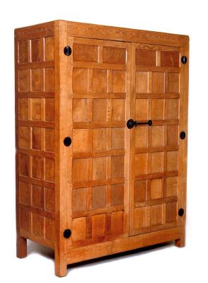 Appraisal: AN ADZED OAK WARDROBE by Robert Mouseman Thompson of panelled