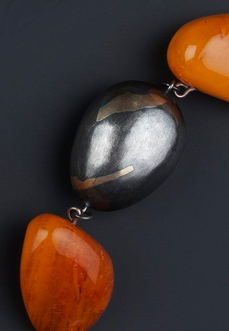 Appraisal: Modernist SchoolBi-metal necklace probably continentalspaced with amber beadsstamped 'Silver K'