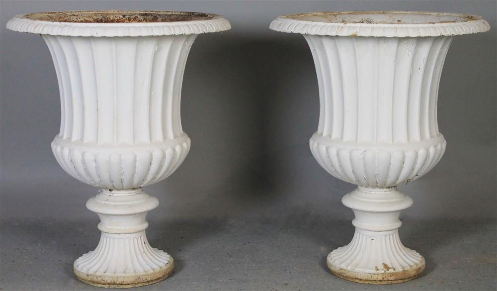 Appraisal: PAIR OF WHITE PAINTED CAST IRON URNS each with everted