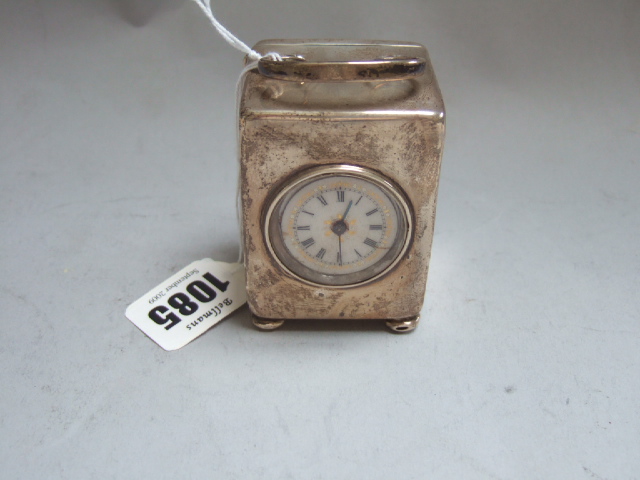 Appraisal: A silver rectangular cased carriage clock raised on four bun