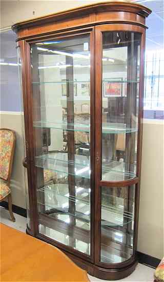 Appraisal: HARDWOOD AND CURVED GLASS CURIO CABINET Pulaski Furniture Co modern