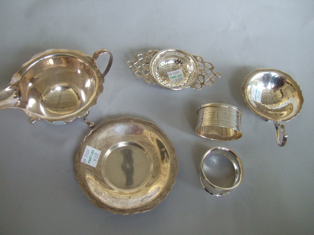 Appraisal: Silver comprising a cream jug Sheffield a tea strainer with