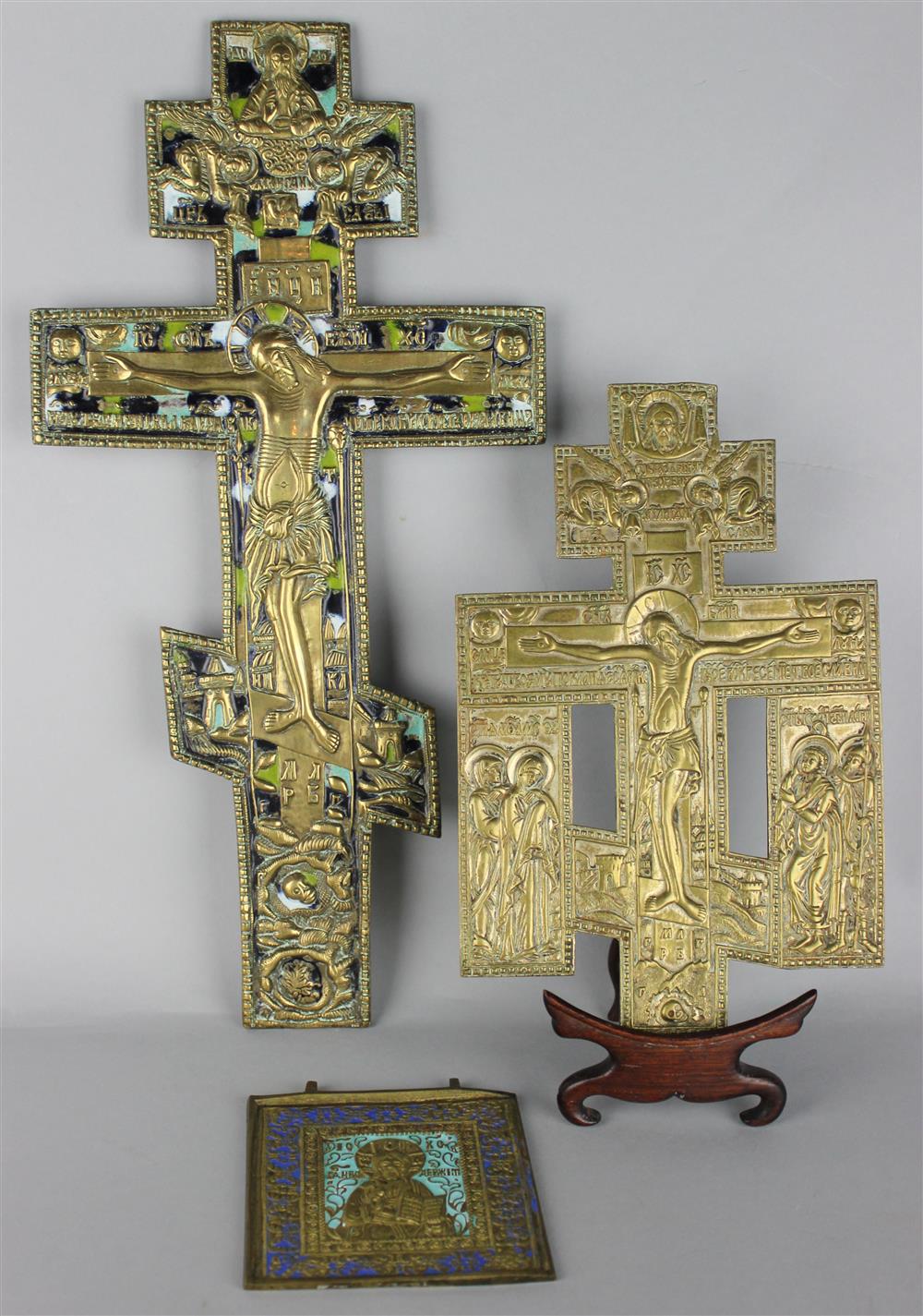 Appraisal: THREE RUSSIAN BRONZE ICONS the first a crucifix with skulls