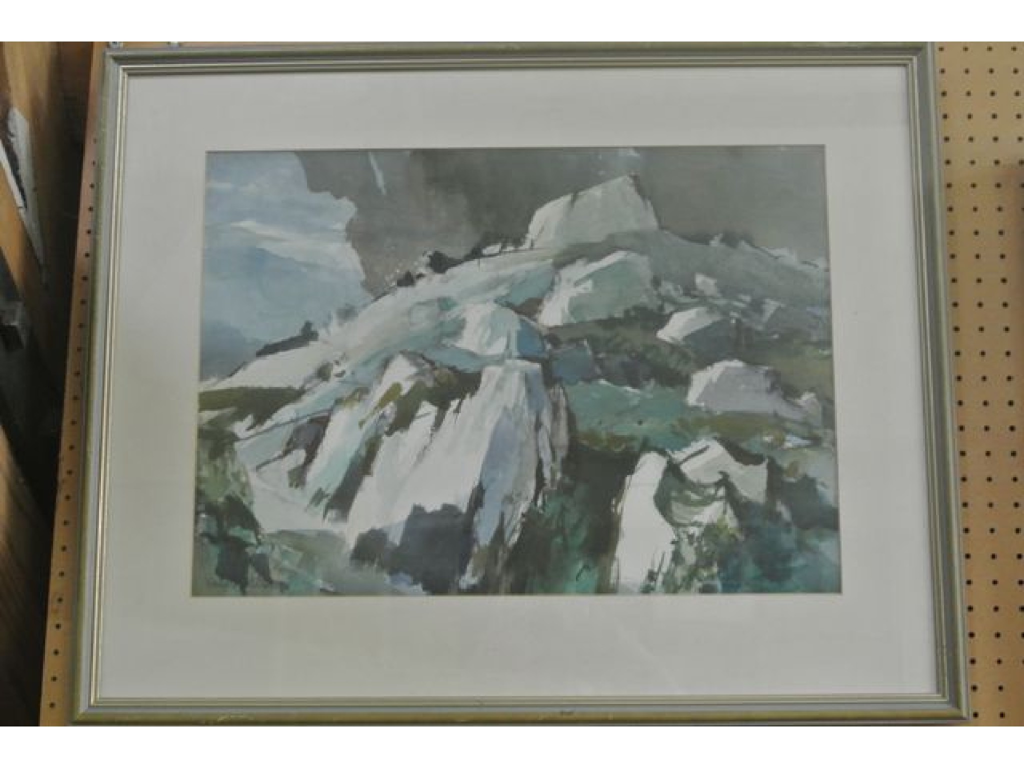 Appraisal: A watercolour of a Welsh landscape with rocky outcrop and