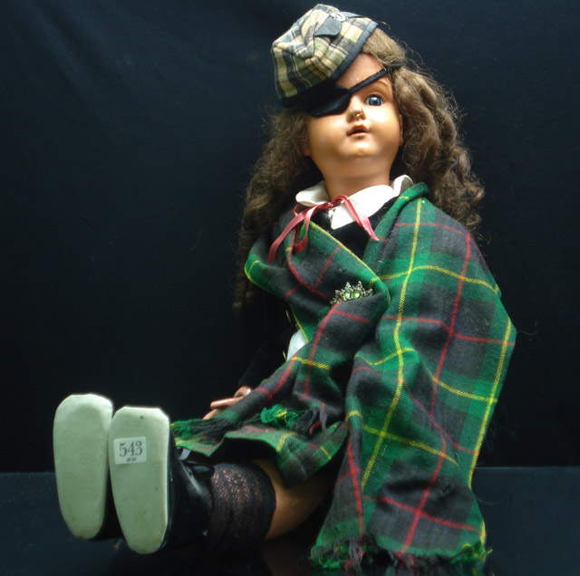 Appraisal: A German character doll with celluloid head original wig sleeping