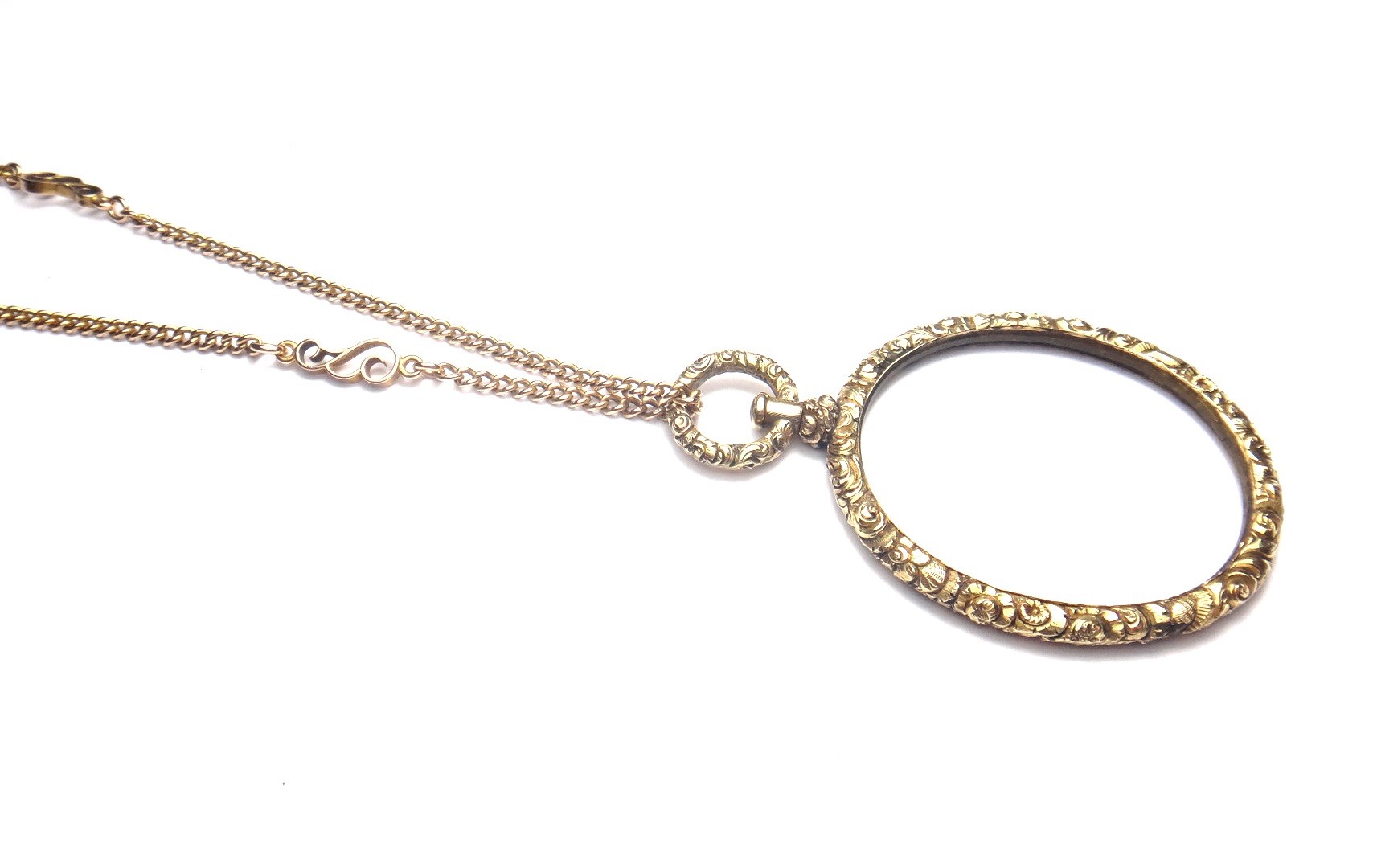 Appraisal: A gold curb link long chain spaced with scroll pierced