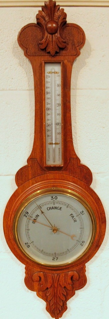 Appraisal: An Edwardian oak cased two dial banjo barometer and thermometer