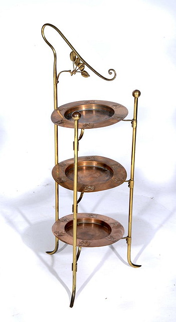 Appraisal: AN ART NOUVEAU BRASS AND COPPER THREE TIER CAKE STAND