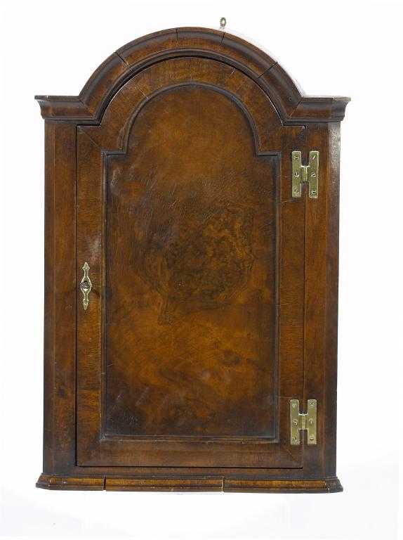 Appraisal: A WALNUT CORNER CUPBOARD in Queen Anne style with breakarched