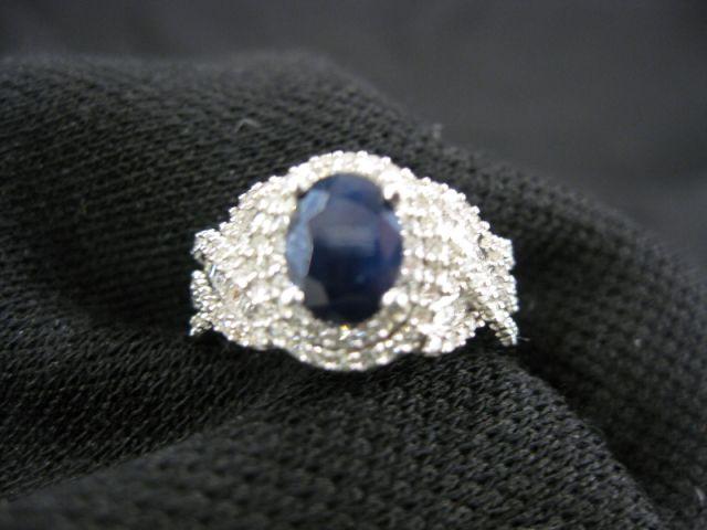 Appraisal: Sapphire Diamond Ring deep blue oval gem weighing carats surrounded