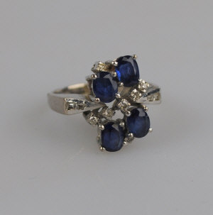 Appraisal: Sapphire and diamond contemporary style ring four oval sapphires and