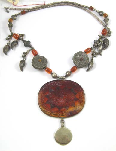 Appraisal: AN ISLAMIC CARNELIAN NECKLACE with incised medallion of Muslim writing