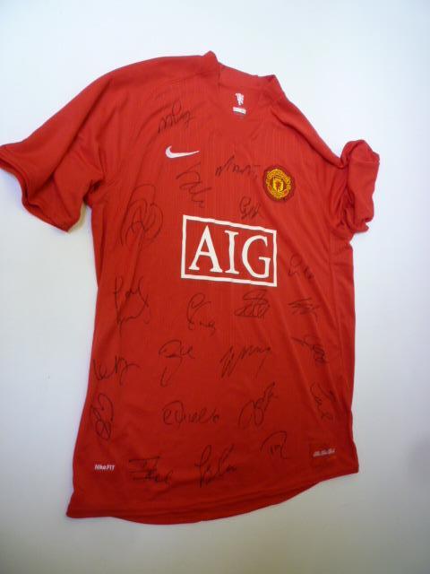 Appraisal: A Manchester United football shirt with twenty one signatures in