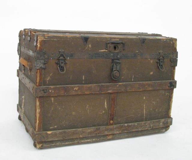 Appraisal: An antique wooden sea trunk with domed top divided interior